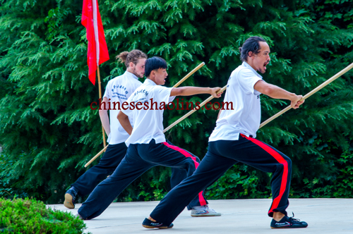 performing shaolin staff by students